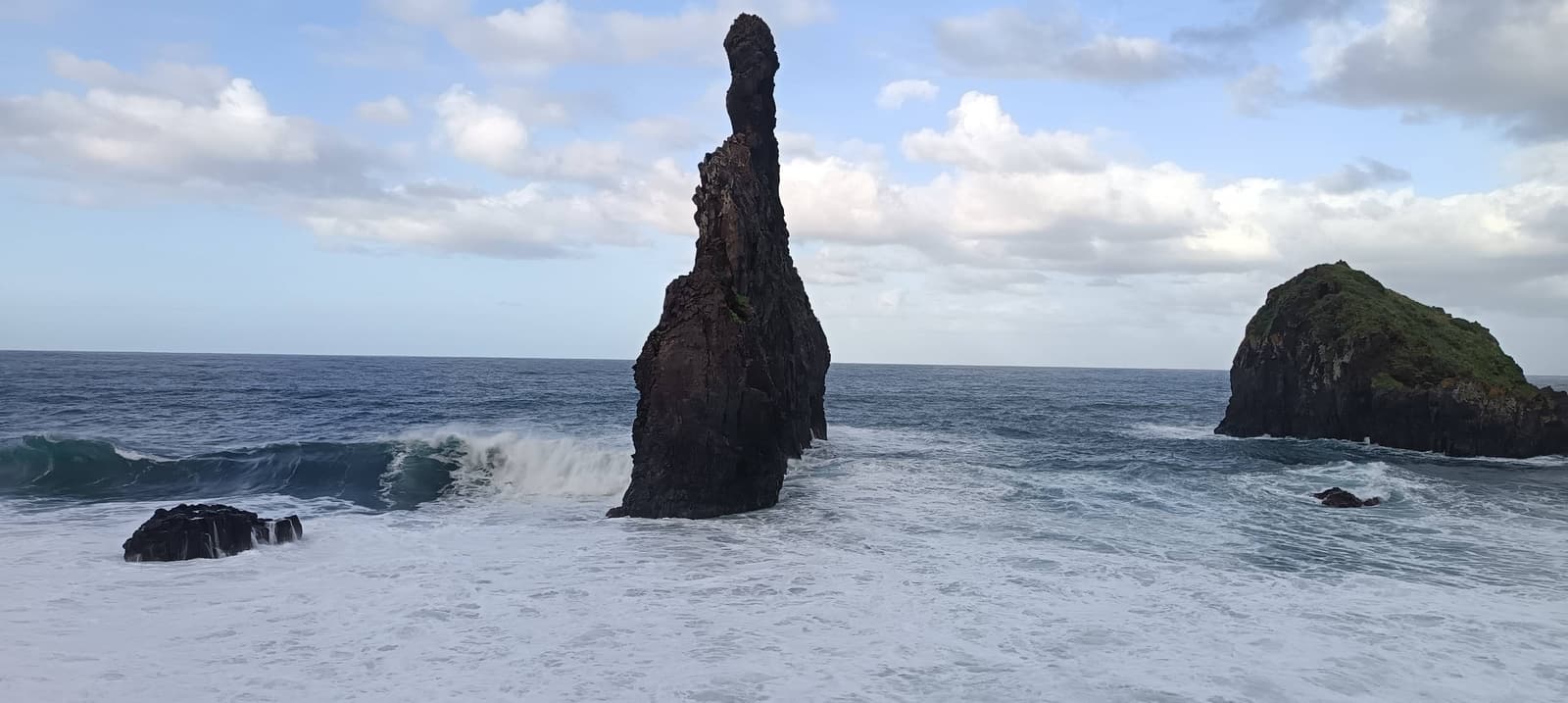 Three rocky sea stacks rising from the ocean off the north coast of Madeira at Ribeira da Janela